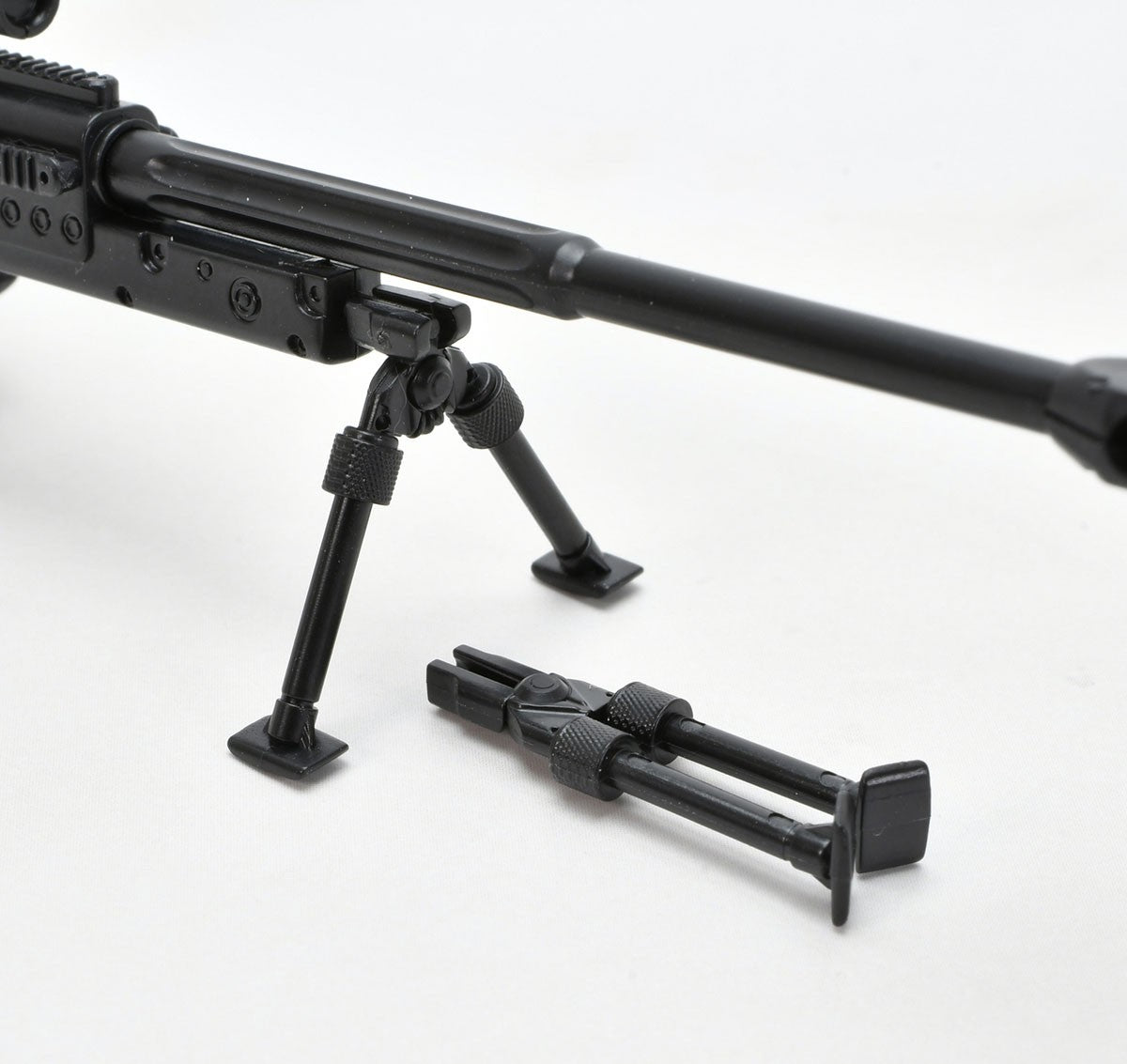 Close-up of the LA-DF39 rifle bipod, one deployed on the barrel and one folded